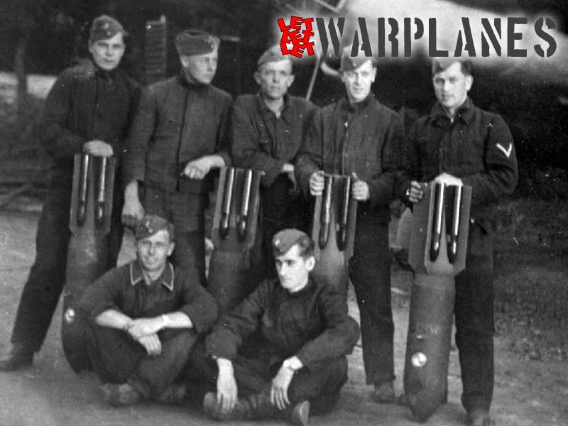 Ground crew holds SC 50 bombs. Note all dark body, possible RLM 71 and all black whistlers. It also have different stencils.